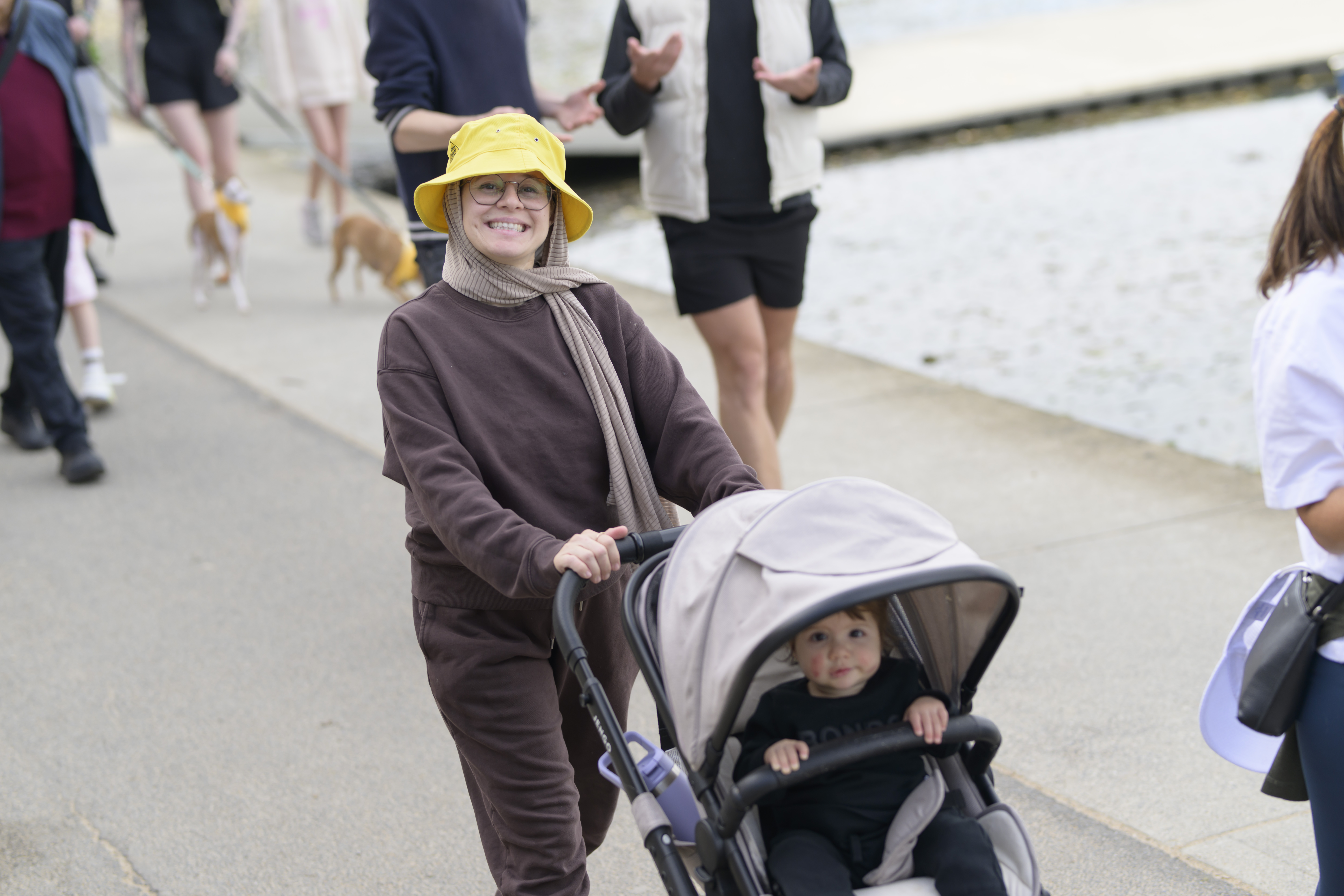 A participant wheeling a pram during Shine a Light on Road Safety Walk & Wheel 2025